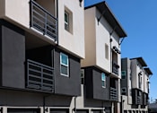 Thumbnail 39 of 102 - A row of modern townhouses with balconies and garages.