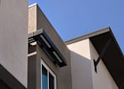 Thumbnail 41 of 102 - A modern building with a clear blue sky in the background.