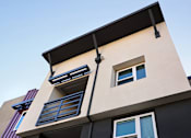 Thumbnail 37 of 102 - A modern building with a balcony and a window.
