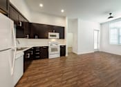 Thumbnail 64 of 102 - A kitchen with dark brown cabinets and white appliances.