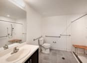 Thumbnail 68 of 102 - A bathroom with a toilet, sink, and shower.