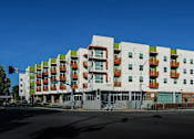 Thumbnail 86 of 94 - A modern multi-story apartment building with balconies on each floor.