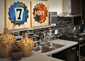 Thumbnail 87 of 94 - A kitchen with a number 7 on a blue bottle cap and a word HOPE on a red bottle cap.