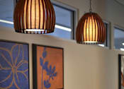 Thumbnail 91 of 94 - A brown wooden table with four chairs and two hanging lights.