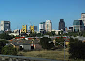 Thumbnail 81 of 94 - A cityscape with a highway in the foreground.