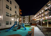 Thumbnail 72 of 94 - A playground with a blue slide and a green pool.