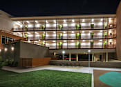 Thumbnail 70 of 94 - A modern building with a pool in the front yard.