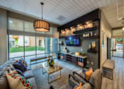 Thumbnail 62 of 94 - A modern living room with a brown leather couch and a glass coffee table.