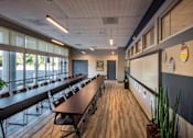 Thumbnail 55 of 94 - A conference room with a long table and chairs.