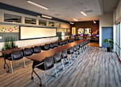 Thumbnail 51 of 94 - A conference room with a long table and chairs.