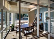Thumbnail 49 of 94 - A glass door with a table and chairs in front of it.