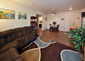 Thumbnail 40 of 94 - A living room with a large brown couch and a rug.