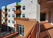 Thumbnail 26 of 94 - A modern building with a balcony and a clear blue sky.