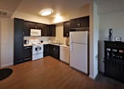 Thumbnail 33 of 94 - A kitchen with black cabinets and a white fridge.