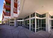 Thumbnail 19 of 94 - A modern building with a glass facade and a white roof.