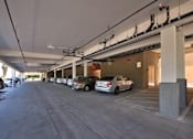 Thumbnail 6 of 94 - A parking garage with cars parked in it.