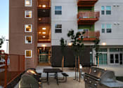 Thumbnail 8 of 94 - A tall building with a red fence in front of it.