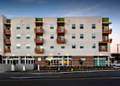 Thumbnail 5 of 94 - A modern apartment building with balconies on the second floor.