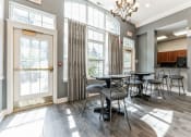 Thumbnail 27 of 44 - a dining room with tables and chairs and large windows at Cumberland Crossing, Cumberland, 02864