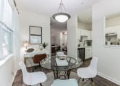 Thumbnail 4 of 44 - an open living room and dining room with a glass table and chairs  at Cumberland Crossing, Cumberland, Rhode Island