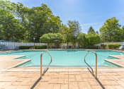 Thumbnail 36 of 44 - a swimming pool with trees and a white fence around it  at Cumberland Crossing, Cumberland, RI, 02864