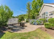 Thumbnail 41 of 44 - a backyard with a patio and trees and a house  at Cumberland Crossing, Rhode Island