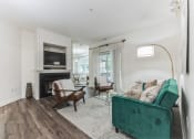 Thumbnail 9 of 44 - living room with a green couch and a fireplace at Cumberland Crossing, Cumberland, 02864