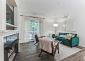Thumbnail 8 of 44 - living room with a fireplace and a green couch at Cumberland Crossing, Cumberland, 02864
