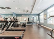 Thumbnail 33 of 44 - a gym with treadmills and other exercise equipment and windows  at Cumberland Crossing, Cumberland, 02864