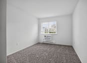 Thumbnail 33 of 52 - A room with a carpet floor and a window with blinds.