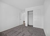 Thumbnail 50 of 52 - A room with a carpeted floor and white walls.