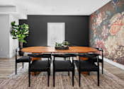 Thumbnail 24 of 52 - A dining room with a round wooden table and six chairs.