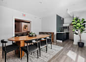 Thumbnail 31 of 52 - A modern dining room with a wooden table and chairs.