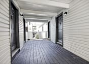 Thumbnail 43 of 52 - A white house with a black door and a black railing.