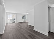 Thumbnail 32 of 52 - A room with wooden floors and white walls.
