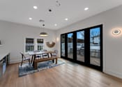 Thumbnail 23 of 38 - A modern living room with a wooden floor and a large window.