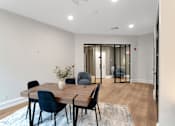 Thumbnail 20 of 38 - A dining room with a table and chairs.