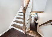 Thumbnail 11 of 14 - an open staircase with wooden treads and a railing up the side of a house at Pleasant View Estates, Griswold, Connecticut
