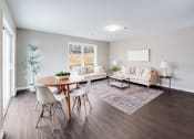 Thumbnail 2 of 14 - a living room with a table and chairs and a couch at Pleasant View Estates, Griswold, 06351