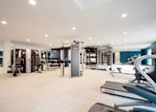 Thumbnail 13 of 16 - A spacious gym with a variety of equipment.