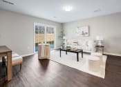 Thumbnail 10 of 14 - a living room with a couch and a table at Pleasant View Estates, Griswold, 06351