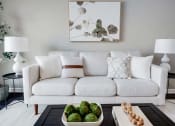 Thumbnail 1 of 14 - a living room with a white couch and a table at Pleasant View Estates, Griswold