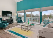 Thumbnail 5 of 57 - A living room with a glass coffee table and a white couch. at South Winds Apartments, Fall River, 02720