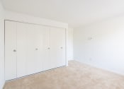 Thumbnail 52 of 57 - A room with a white wall and a carpeted floor. at South Winds Apartments, Fall River, 02720