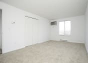 Thumbnail 50 of 57 - A white room with a carpeted floor and a window. at South Winds Apartments, Fall River