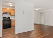 Thumbnail 44 of 57 - A kitchen with wooden cabinets and a black oven. at South Winds Apartments, Massachusetts
