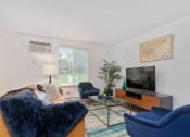 Thumbnail 15 of 57 - Living Room With TV at South Winds Apartments, Massachusetts, 02720