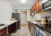 Thumbnail 15 of 20 - A kitchen with a refrigerator, stove, and oven.