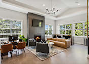 Thumbnail 1 of 20 - A modern living room with a fireplace and a television.