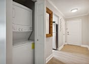 Thumbnail 20 of 20 - A white washing machine is in a small laundry room.